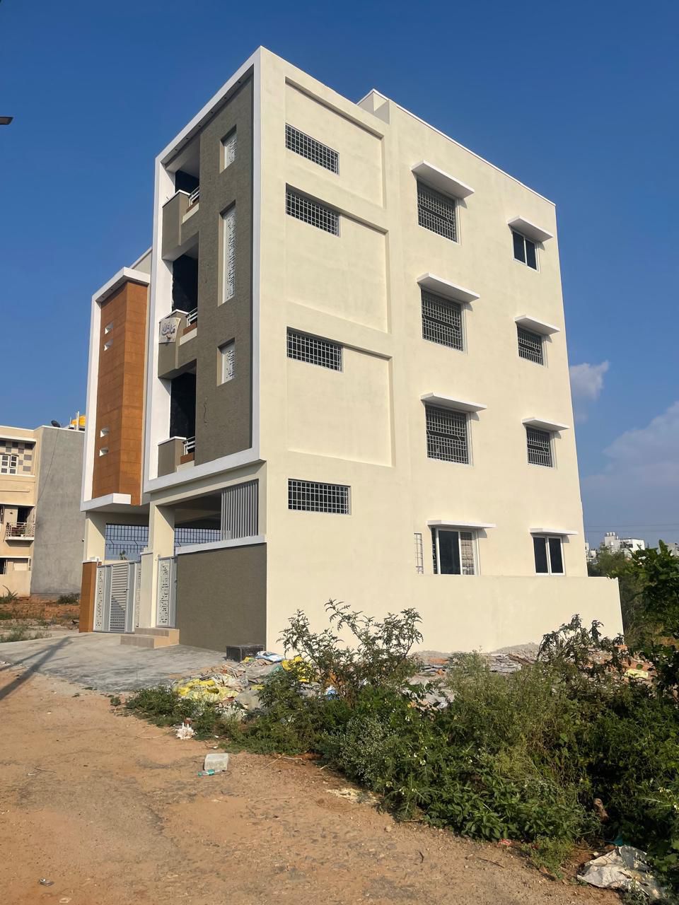 Contemporary Multi-Floor Building with Wood Accent Panels and uPVC Windows