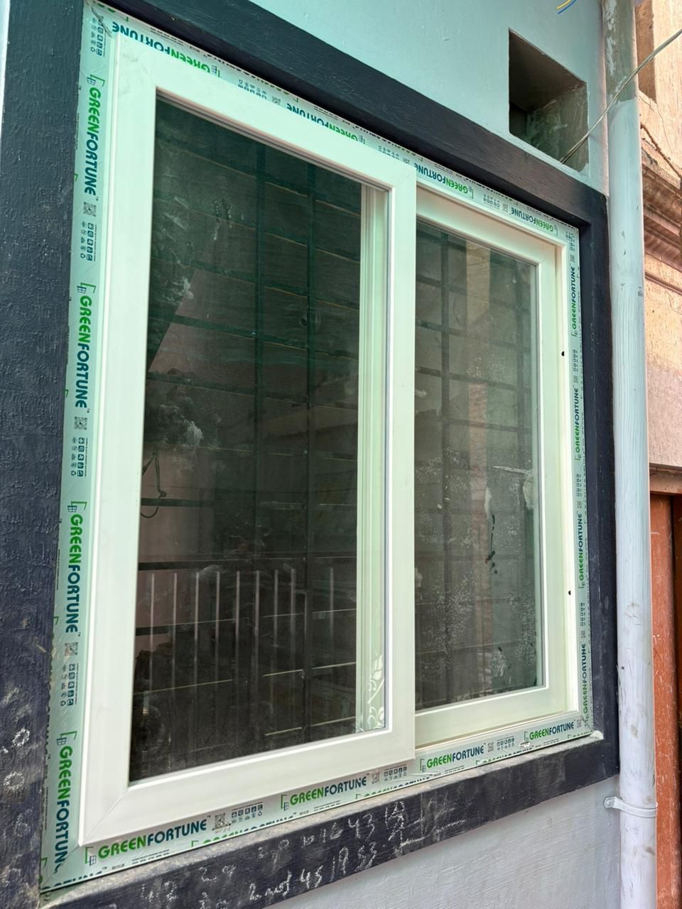 Two-Track uPVC Sliding Window with Greenfortune Protective Tape on Grey Exterior