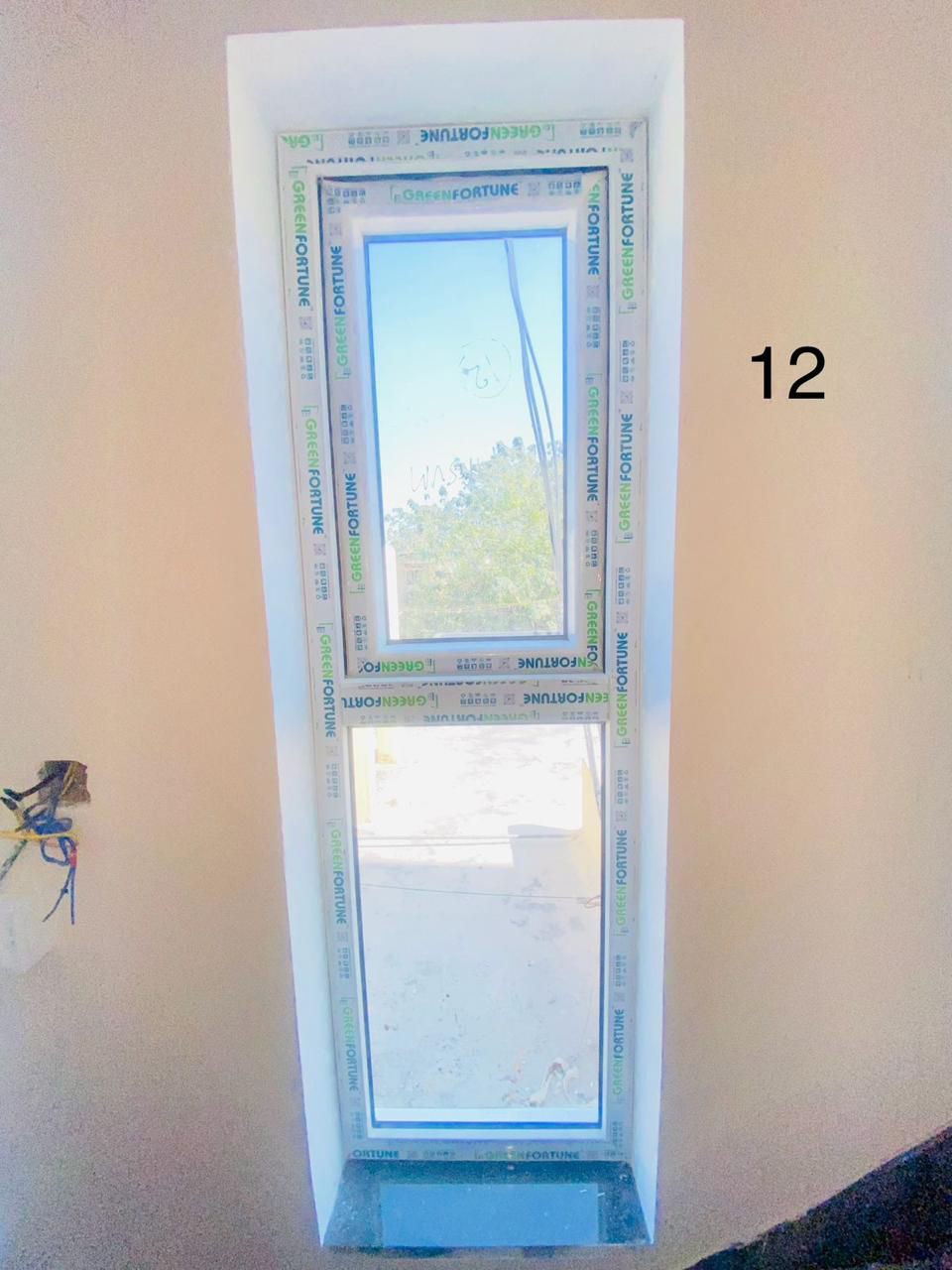 Tall Vertical Frosted Ventilator Window in Interior Staircase