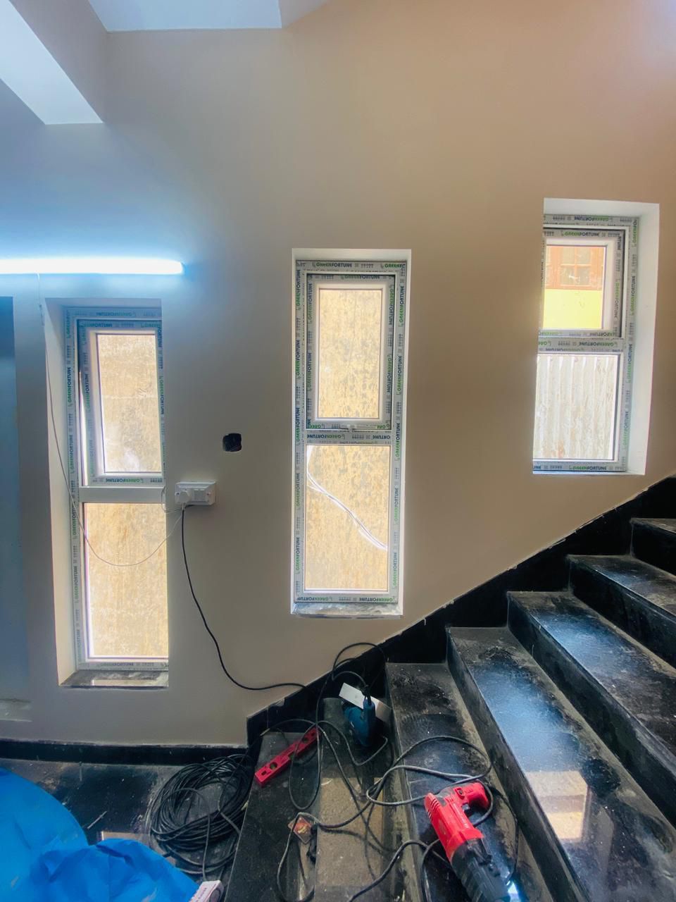 Stairwell Featuring Three Vertical Frosted Windows Providing Natural Daylight