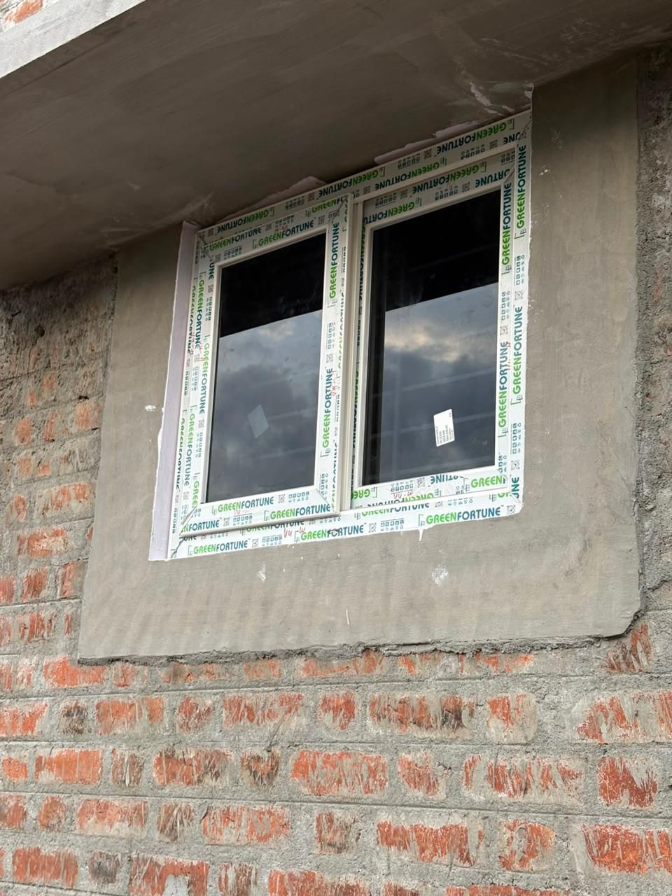White uPVC Window Unit Installed in Raw Brick Masonry Structure